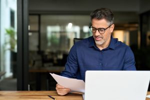 Confident man managing members with an online member directory